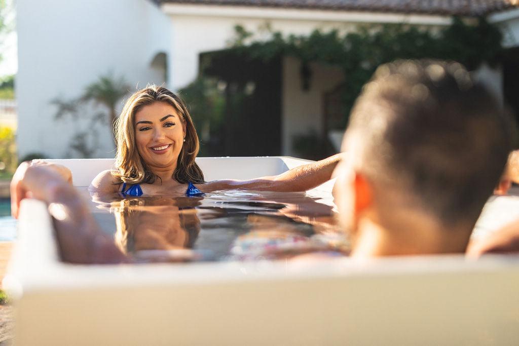 woman facing man in regen cold plunge tub